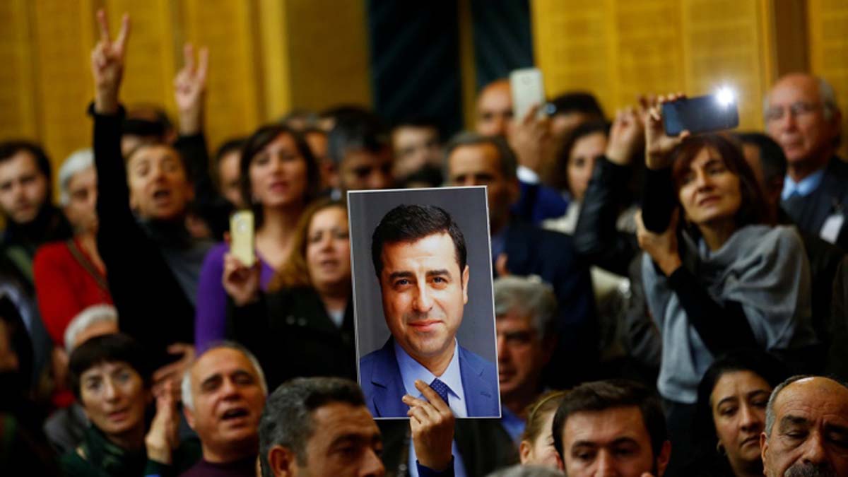 A supporter holds a portrait of detained leader of Turkey's pro-Kurdish opposition Peoples' Democratic Party (HDP) Selahattin Demirtas at the Turkish parliament in Ankara