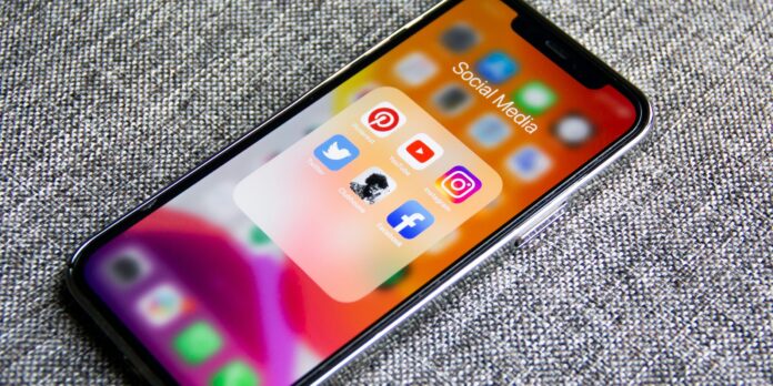 black iphone 5 on gray textile