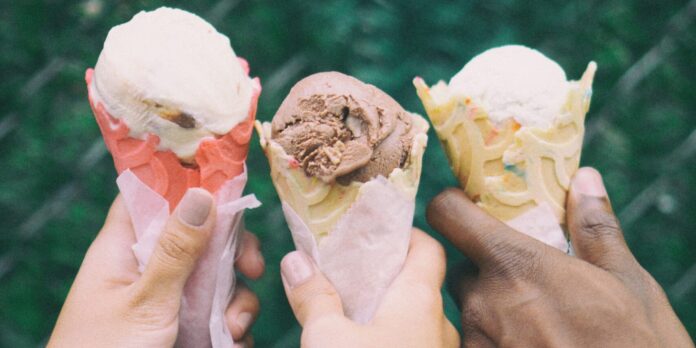 three people holding ice cream cones in their hands