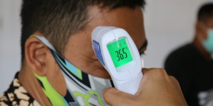 saglik man in green white and blue shirt wearing white and blue digital watch