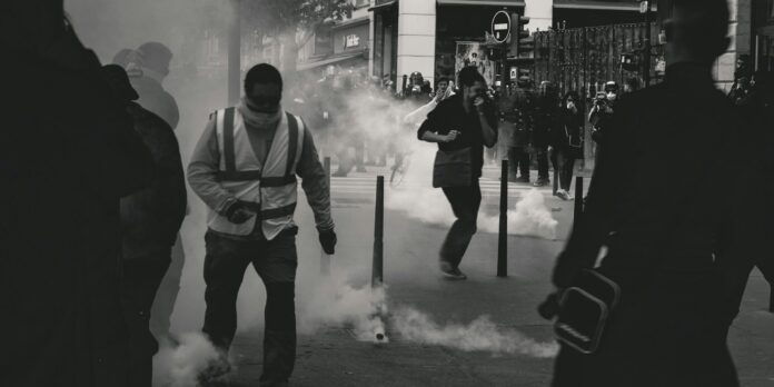 grayscale photo of people grayscale photo of people near smoke