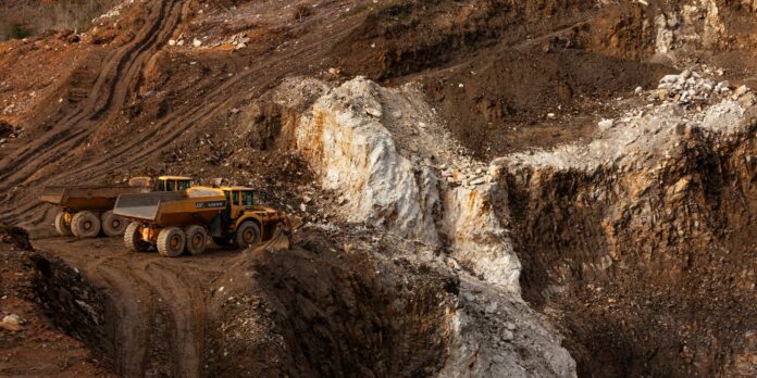 a large truck driving down a dirt road