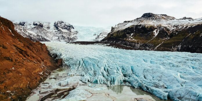 frozen river in the middle of rock mountains