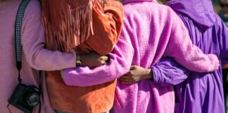 Kadınlar Şiddet ve Yoksulluk Kıskacında: ‘Aile Yılı’ Gerçek Çözüm mü? four person holding each others waist at daytime